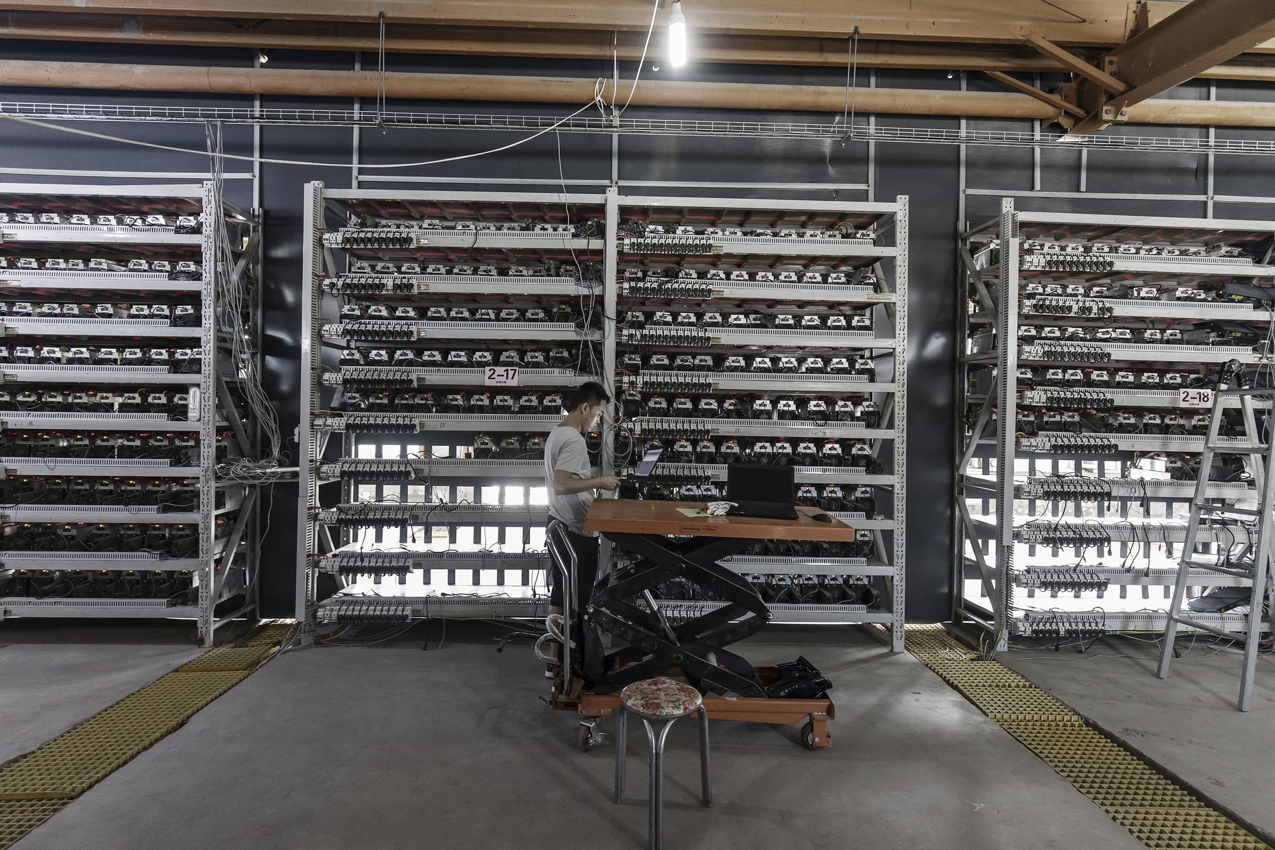 China S Bitcoin Trade Seen Continuing Despite Crackdown The - a worker inspects bitcoin mining machines at a facility in ordos inner mongolia china